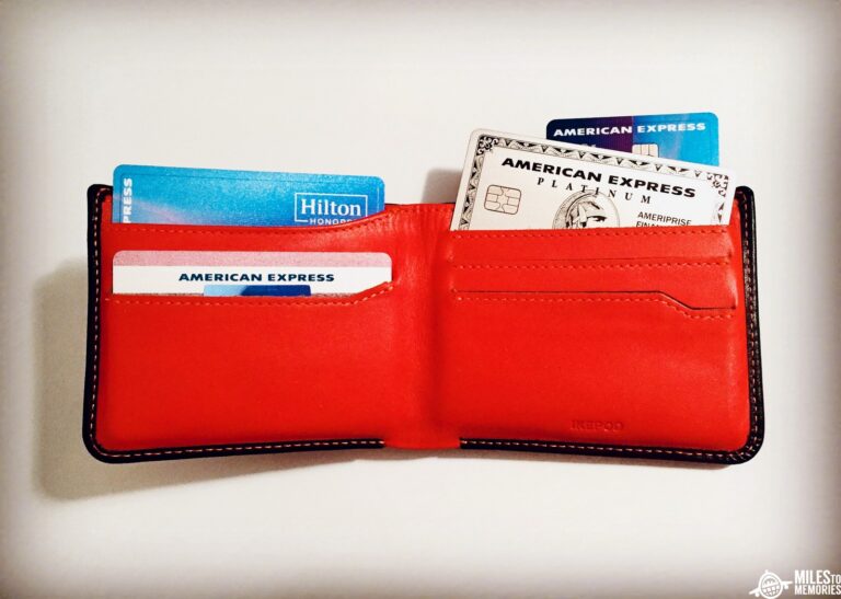 a red wallet with credit cards and cards inside