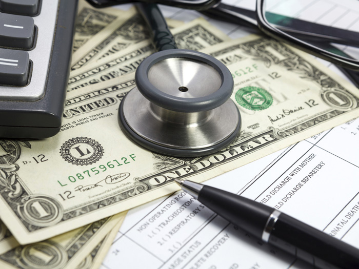 Pen stethoscope glasses and dollar on blank Patient information