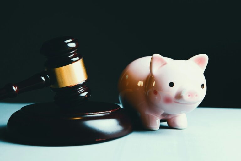 pink pig ceramic figurine on black and white round plate; financial discipline