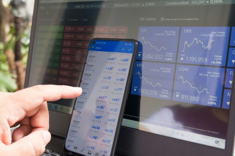 black android smartphone turned on screen; young forex traders