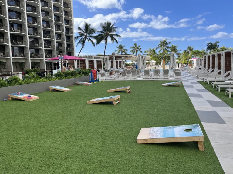 a lawn with a game board and chairs